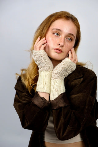 Handmade Handschuhe in fingerlosem Stil aus Schurwolle-Mix-Garn in Cremeweiß mit Zopfstrickdetails in Beige. Das Bündchen kann je nach Belieben auch umgeschlagen getragen werden.