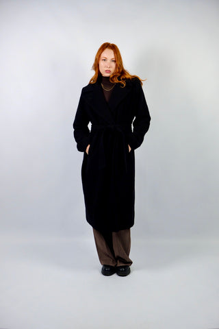 Hochwertiger, schwarzer 00s Wollmantel mit Kaschmir-Anteil – klassisch und elegant geschnitten, mit seitlichen Eingrifftaschen und Bindegürtel – die angegebene Größe ist L, fällt unserer Einschätzung nach kleiner aus; wir empfehlen den Mantel einer M oder S/M (bitte Maße beachten) – ein absolutes Highlight