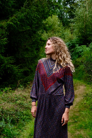 Hochwertiges 70s Maxikleid made in Italy mit Boho Muster in Dunkelrot, Blau, Türkis, Senf, Weiß und Schwarz, mit Knopfleiste an der Schulter, Stehkragen, leichten Ballonärmeln und stretchy Gummizugbund in der Taille – ein seltenes Fundstück und absolutes Highlight – wir empfehlen das Kleid der heutigen Zwischengröße S/M (bitte Maße beachten)