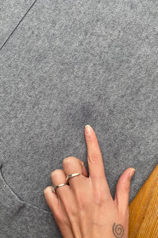 Grau meliertes Preloved (Secondhand) Herbstkleid aus einer Boutique, weicher Strickstoff und lässiger Schnitt mit aufgesetzten Taschen und Fransen – tragbar von einer S bis M