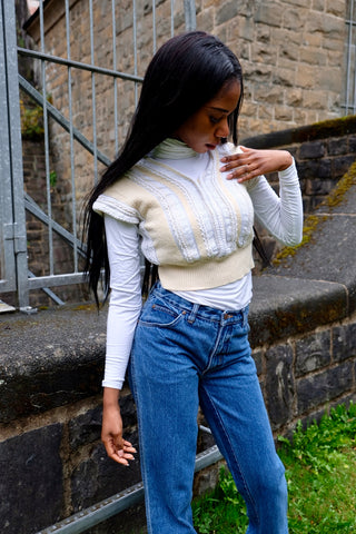 80s/90s Pullunder/Stricktop made in France mit V-Ausschnitt vorn und am Rücken, hübschem Zopfstrickmuster und Knopfdetails hinten; die Farbe ist ein tolles Vanillegelb/Beige und Weiß, der Pullunder ist cropped geschnitten und ideal für eine XS – ein absolutes Highlight