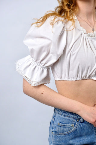 Traumhafte weiße 80s Folklore Dirndlbluse in typisch verkürztem Schnitt mit Gummizugsaum, tollen Puffärmeln und Details aus Lochspitze – made in Germany/Bavaria und ca. tragbar von einer XS bis S je nach gewünschter Passform (bitte Maße beachten) – ein absolutes Highlight