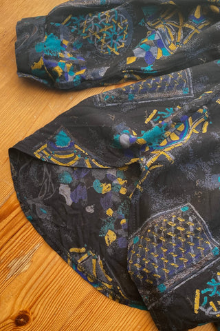 90s Bluse made in Italy aus reiner Viskose mit Crazy Pattern Print in Schwarz, Türkis, Blau, Grau, Braun und Senfgelb – entspricht ca. einer M, eignet sich aber auch ideal für oversized Looks an kleineren Größen