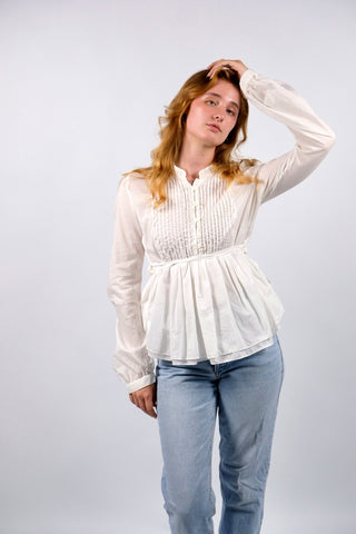 Traumhafte, weiße Preloved (Secondhand) Premium Babydoll-Bluse des italienischen Luxuslabels Dondup (made in Italy). Aus hauchzarter, reiner Baumwolle gefertigt, mit plissierter Brustpartie, leichten Ballonärmeln, kleinem Stehkragen und femininem Schößchen in zweilagigem Design, das sich mit feinen Bändern taillieren lässt – entspricht einer deutschen M und ist auch von einer S tragbar (bitte Maße beachten) – ein absolutes Designer-Highlight
